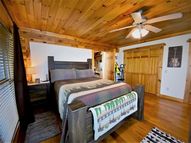 bedroom with wooden ceiling, baseboards, and wood finished floors