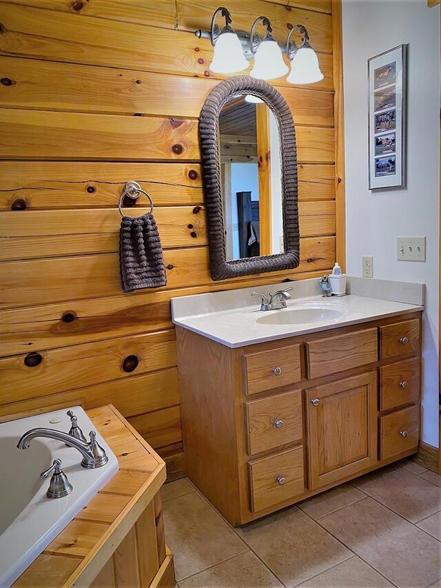 bathroom with tile patterned flooring, wooden walls, vanity, and a garden tub