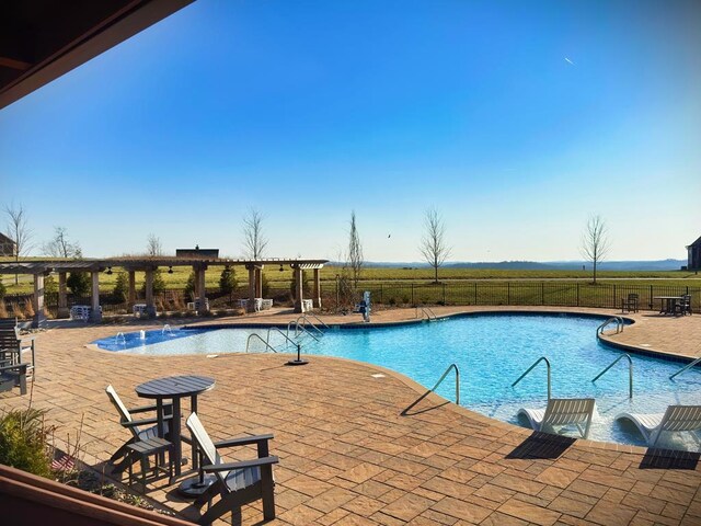 pool with a patio area, fence, and a pergola