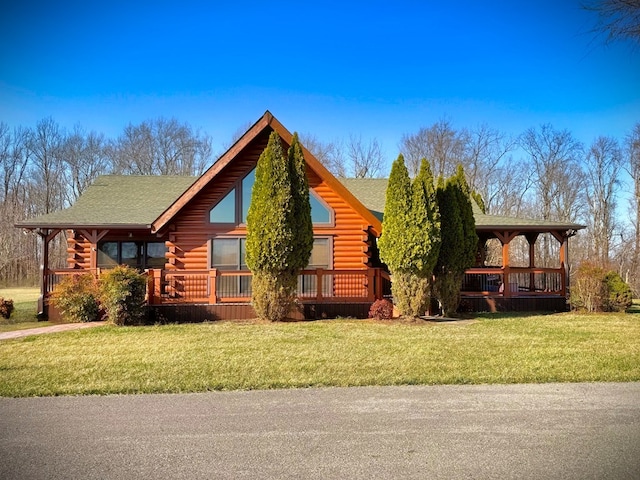 view of side of property with a porch, a lawn, and log exterior