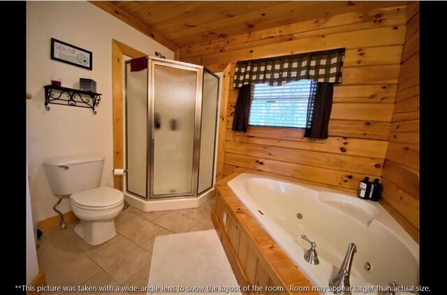 bathroom featuring tile patterned floors, a whirlpool tub, a shower stall, and wood walls