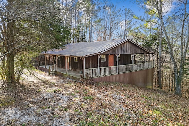 view of front facade featuring covered porch and metal roof