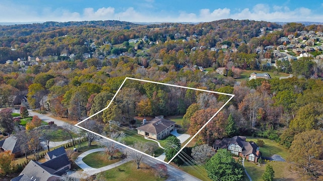 birds eye view of property featuring a wooded view and a residential view