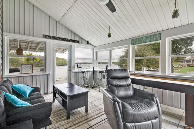 sunroom featuring a ceiling fan, lofted ceiling, and radiator heating unit