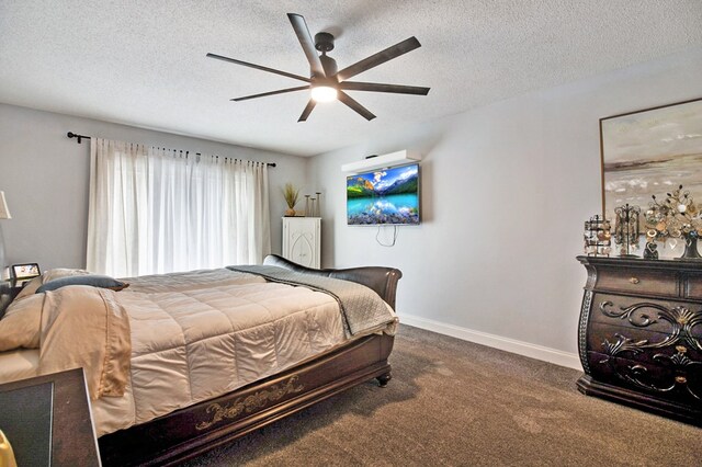 bedroom featuring a textured ceiling, dark carpet, a ceiling fan, and baseboards