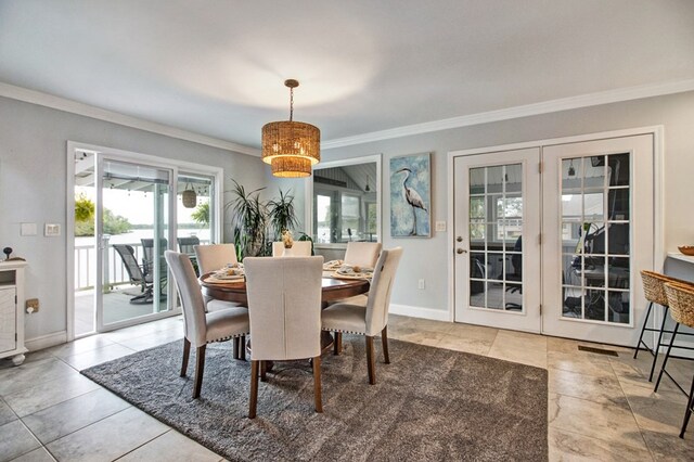 dining area featuring baseboards, crown molding, and french doors