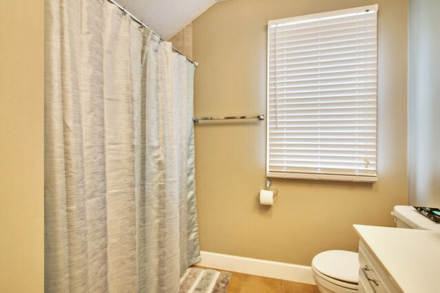 bathroom with baseboards, toilet, a shower with curtain, lofted ceiling, and vanity