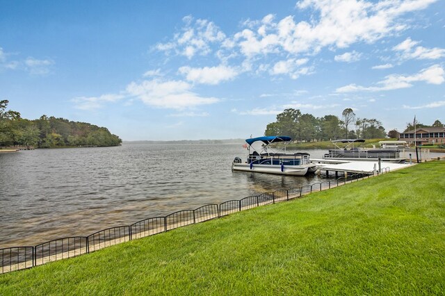 view of dock featuring a yard and a water view