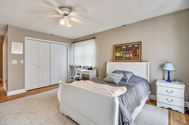 bedroom featuring baseboards, a closet, a ceiling fan, and wood finished floors