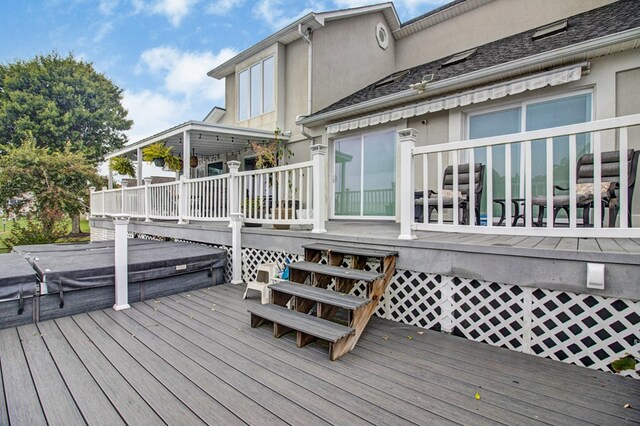 wooden terrace featuring a covered hot tub