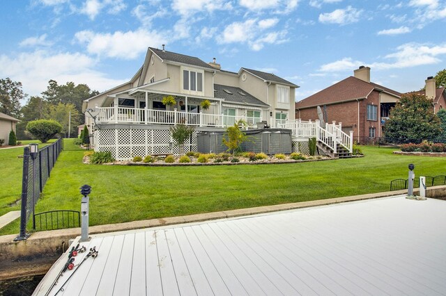 rear view of property with stairway, fence, a deck, and a yard