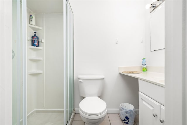 full bathroom featuring toilet, a shower stall, vanity, baseboards, and tile patterned floors