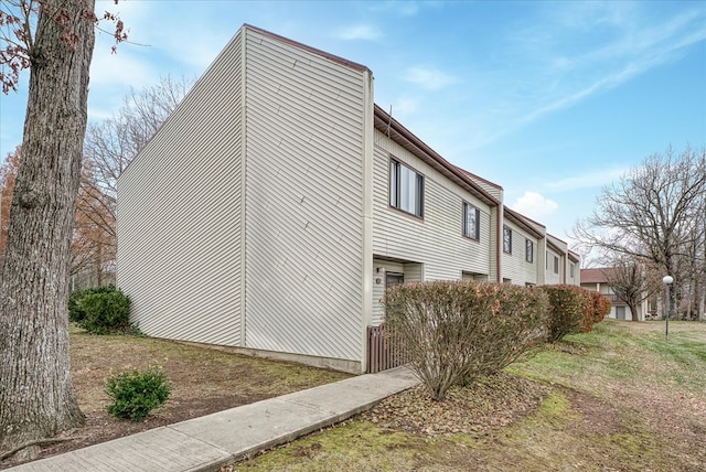 view of side of property featuring a yard