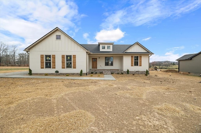 modern farmhouse style home with roof with shingles and board and batten siding