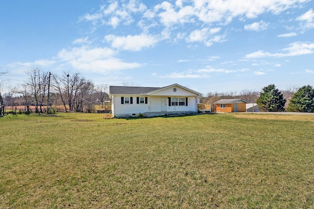 view of front of property with a front lawn and an outdoor structure