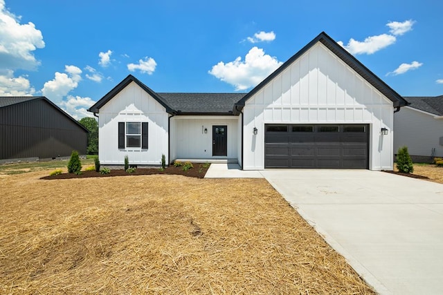 modern farmhouse style home featuring driveway, a shingled roof, board and batten siding, and an attached garage