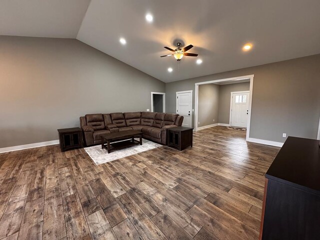 living room featuring ceiling fan, lofted ceiling, recessed lighting, baseboards, and dark wood-style floors