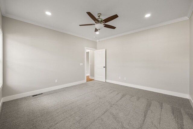 unfurnished room featuring baseboards, visible vents, and crown molding