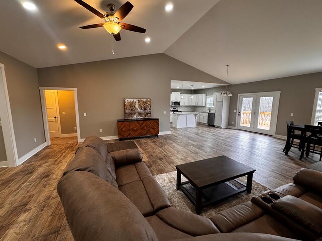 living room featuring recessed lighting, wood finished floors, a ceiling fan, and baseboards