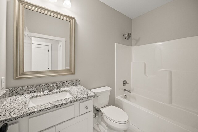 bathroom featuring bathtub / shower combination, vanity, and toilet