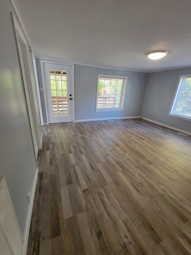 spare room with wood finished floors and baseboards