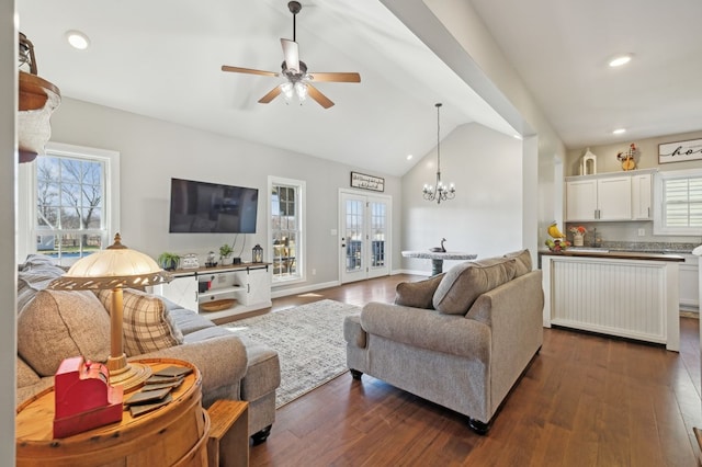 living room with vaulted ceiling, french doors, dark wood-type flooring, and a healthy amount of sunlight