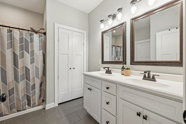 bathroom featuring double vanity, tile patterned flooring, a sink, and a shower with shower curtain