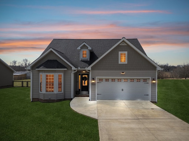 view of front facade with an attached garage, fence, a front lawn, and concrete driveway