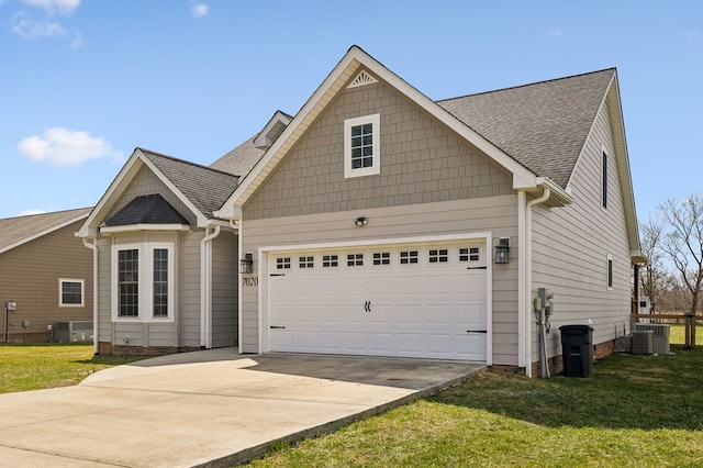 view of front of house featuring a garage, a front yard, concrete driveway, and roof with shingles