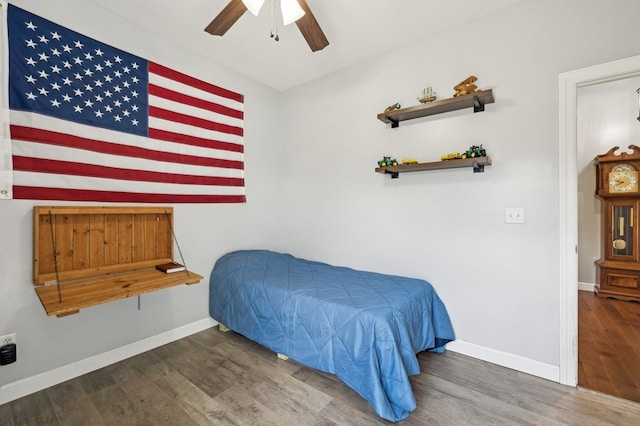 bedroom featuring ceiling fan, wood finished floors, and baseboards