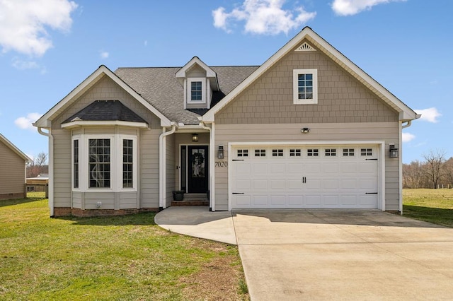 view of front facade featuring a garage, driveway, a front lawn, and a shingled roof