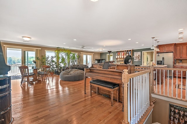 living area with light wood finished floors, recessed lighting, and ornamental molding