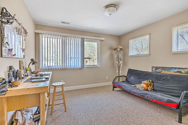 carpeted home office with visible vents and baseboards