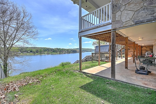 view of yard featuring a water view and a patio area