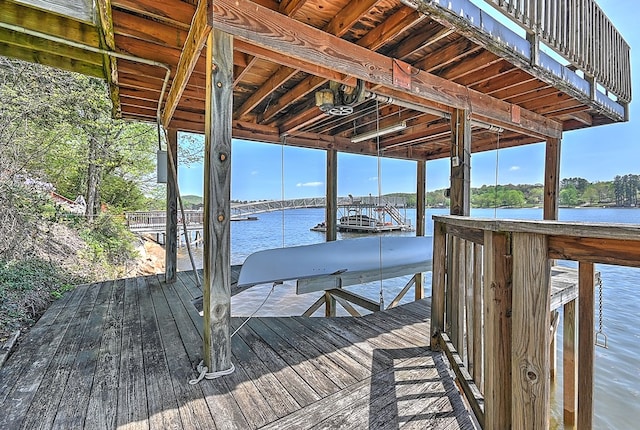 view of dock featuring boat lift and a water view