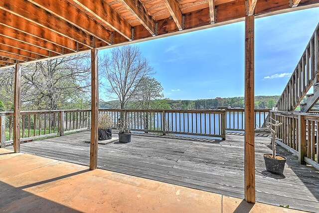 wooden terrace featuring a water view