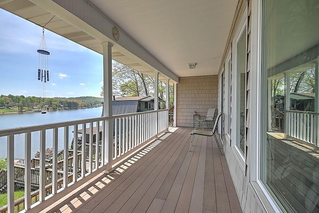 wooden deck featuring a water view