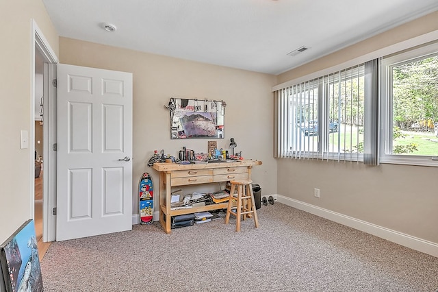 carpeted office space featuring visible vents, plenty of natural light, and baseboards