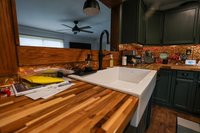 kitchen featuring a ceiling fan, backsplash, dark wood-style flooring, wooden counters, and a sink