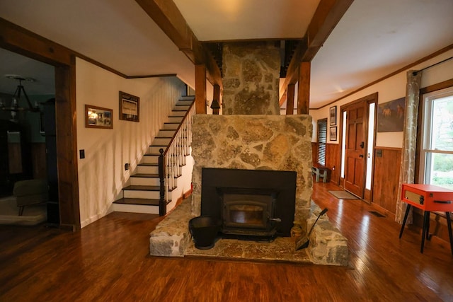 living area featuring stairs, wainscoting, wood finished floors, and crown molding