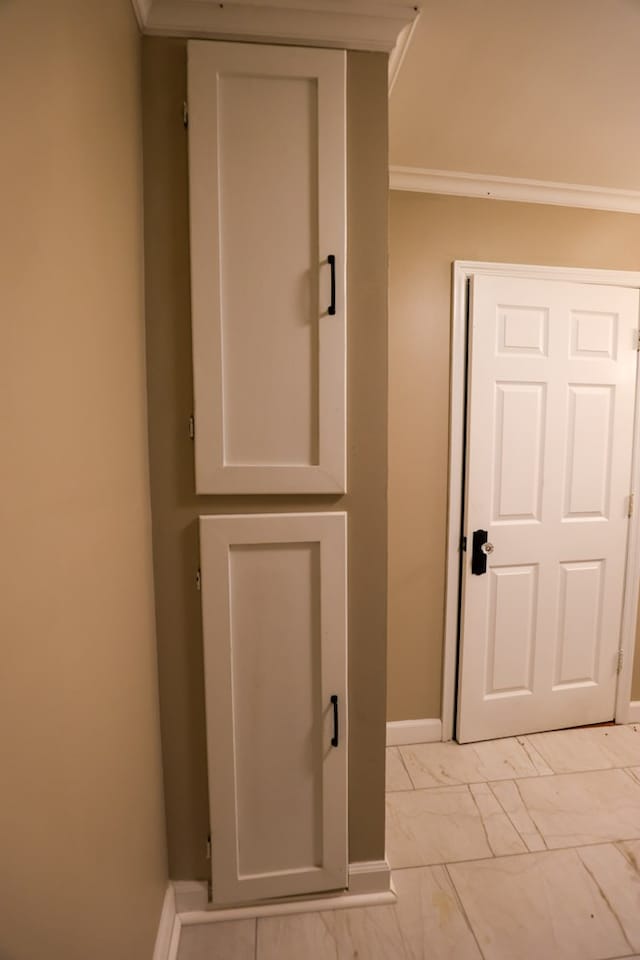 corridor with marble finish floor and baseboards