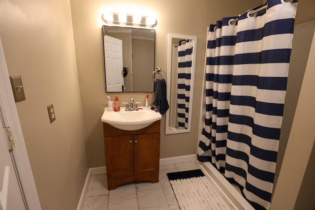 bathroom featuring marble finish floor, a shower with shower curtain, vanity, and baseboards