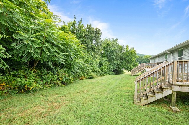 view of yard with stairway and a wooden deck