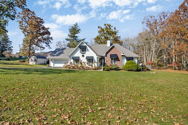 single story home featuring a garage, metal roof, a chimney, and a front lawn