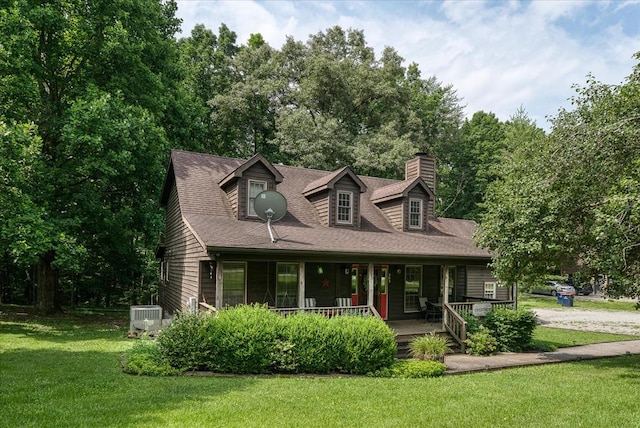 cape cod house featuring a chimney, a porch, a shingled roof, cooling unit, and a front lawn