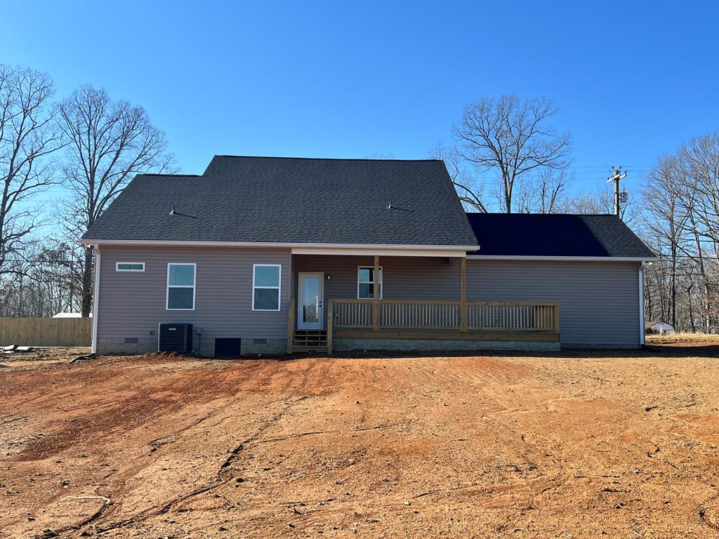 rear view of house featuring crawl space, central AC unit, a porch, and roof with shingles