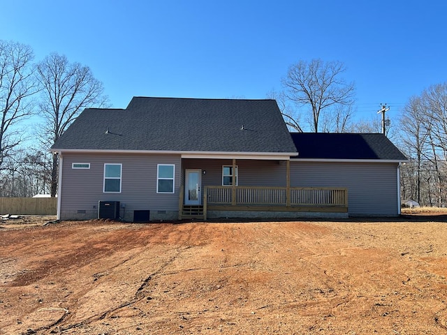 rear view of house featuring crawl space, central AC unit, a porch, and roof with shingles