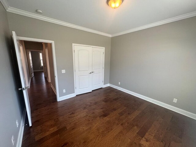 bathroom featuring vanity, a walk in closet, a relaxing tiled tub, and baseboards