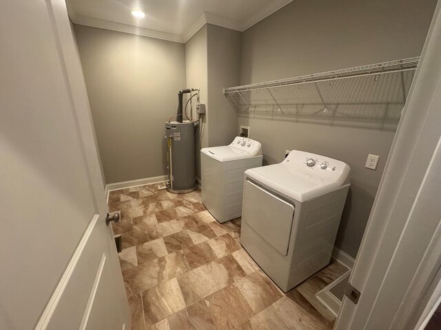 laundry area with water heater, laundry area, independent washer and dryer, and baseboards