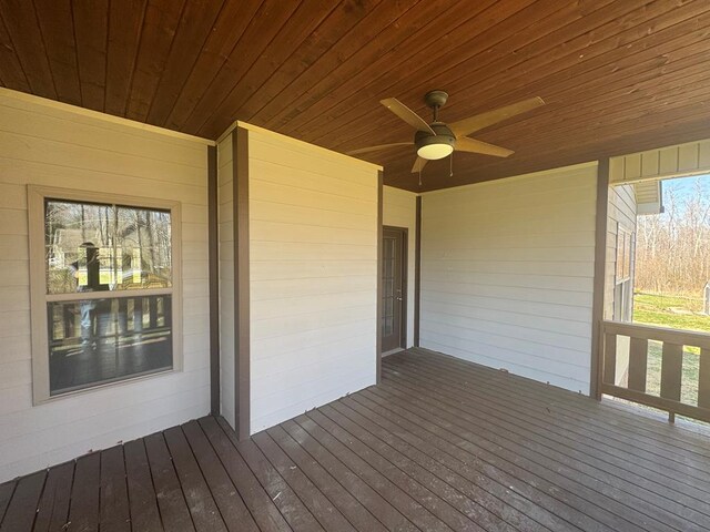 wooden deck featuring a ceiling fan